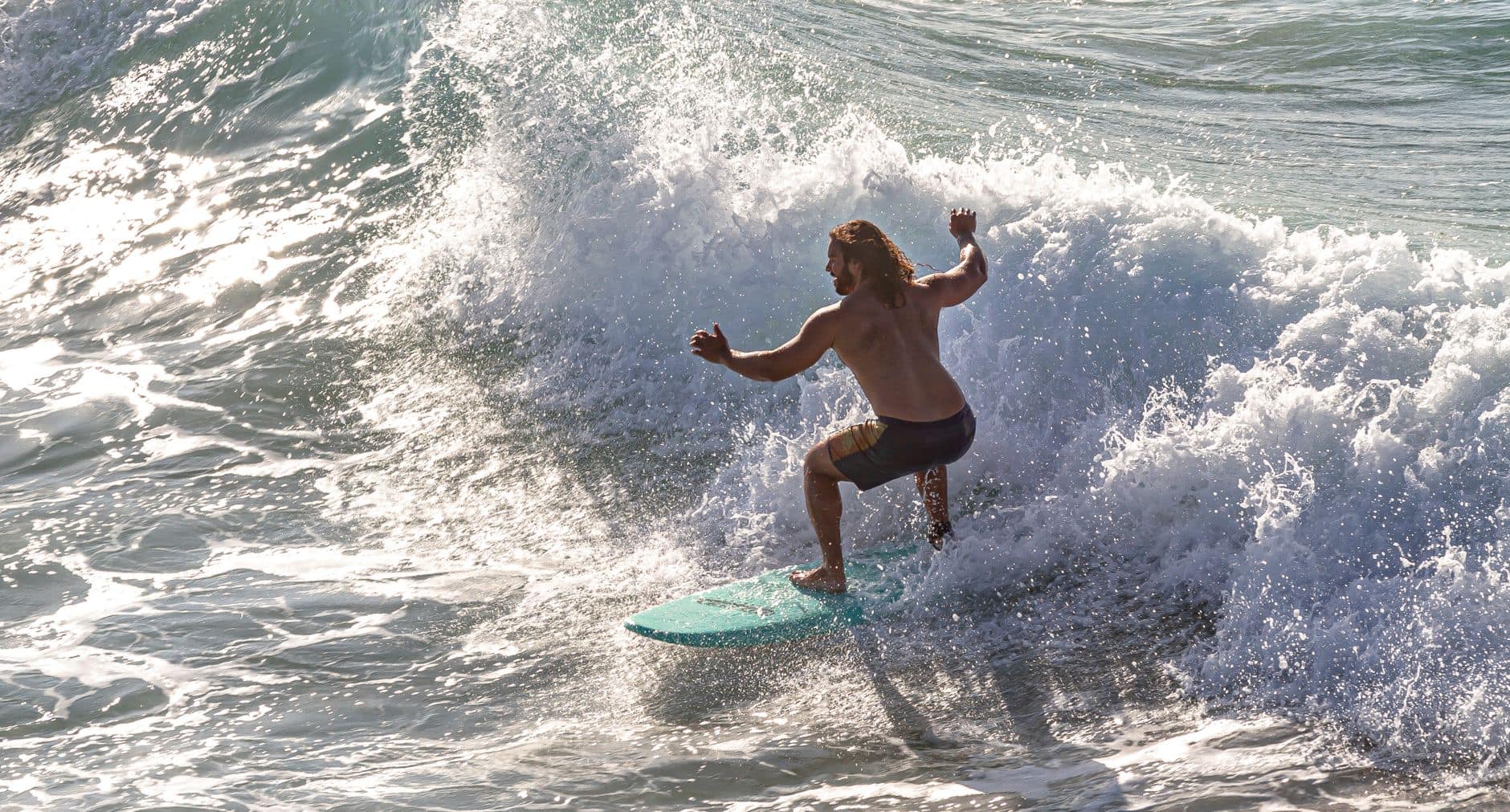 Surfer riding powerful waves in Byron Bay, Australia, showcasing thrilling ocean adventure.