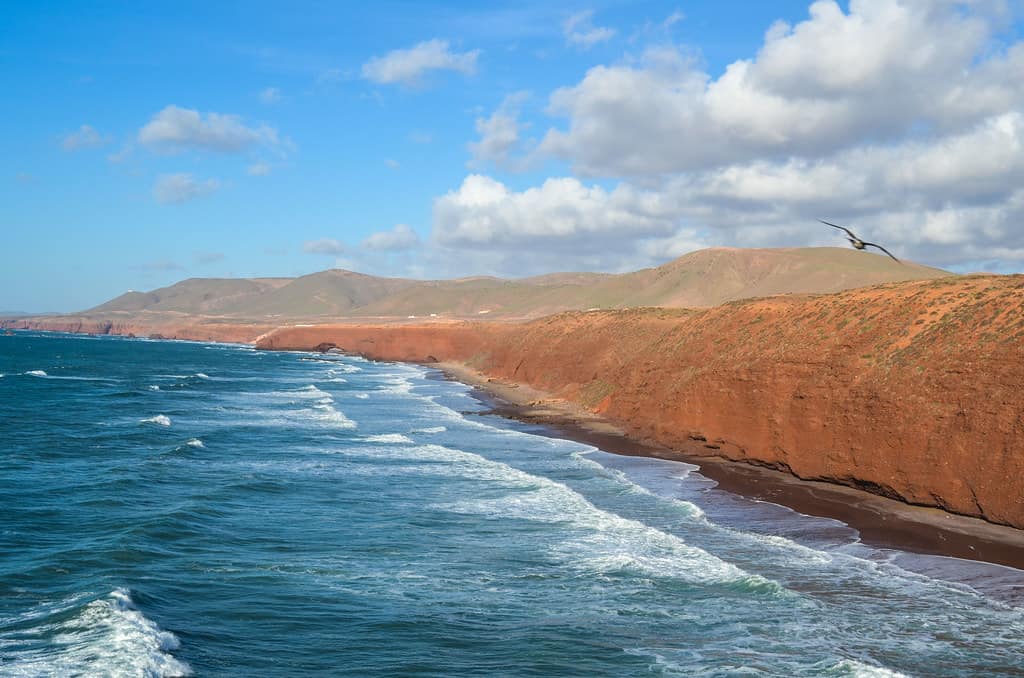 Cycling along the coast of Legzira, Morocco